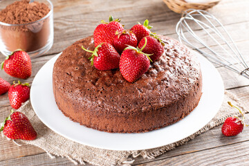 Chocolate sponge cake with strawberry on a table