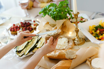 Woman making a sandwich at the festive table.