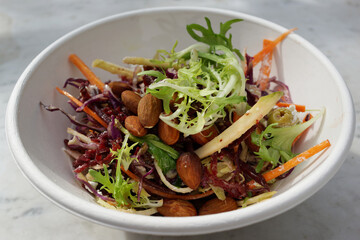 A bowl of salad with roasted almond nuts