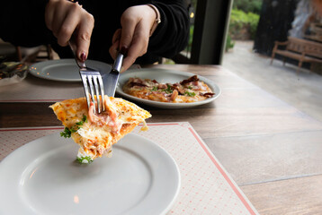 Ham, Bacon, Thin Crust Pizza.Delicious pizza with salami, sausages, mozzarella and tomato sauce ready for served.