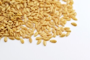 Golden flax seeds, white background