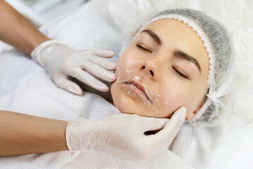 Fototapeta na wymiar Professional permanent makeup artist applying anesthetic cream