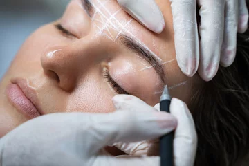 Fotobehang Woman during professional eyebrow mapping procedure © blackday