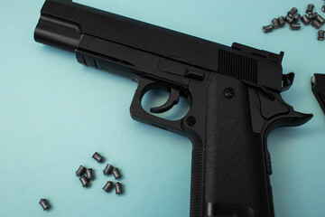 Big beautiful black pistol lies on a blue background