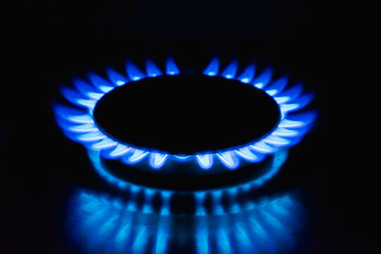 Flame of a gas burner on a black background. Combustion of Natural gas on a black background. Gas stove. Gas stove burner on fire. Fossil fuel. Hydrocarbons. Gas crisis in Europe.