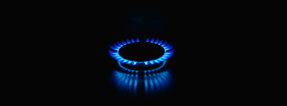 Flame of a gas burner on a black background. Combustion of Natural gas on a black background. Gas stove. Gas stove burner on fire. Fossil fuel. Hydrocarbons. Gas crisis in Europe.