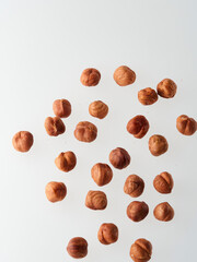 Hazelnut nuts, close up. Beautiful arrangement of scattered hazelnut nuts isolated on white background. Food template with Copy Space for Design. Top view. Flat lay.