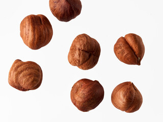 Hazelnut nuts, close up. Beautiful arrangement of scattered hazelnut nuts isolated on white background. Food template with Copy Space for Design. Top view. Flat lay.