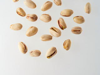 Pistachios isolated on a white background, top view. Flat lay