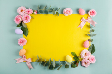 Naklejka na ściany i meble Happy Easter concept with easter eggs and spring flowers. Easter background with copy space. Flat lay.