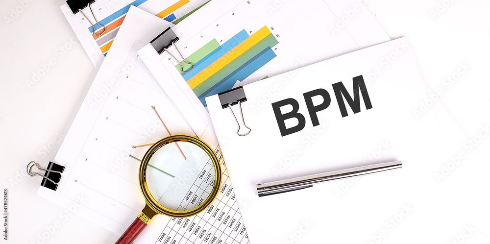 Poster bpm text on white paper on a light background with charts paper