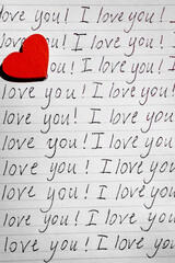 A red wooden heart on a piece of paper with the words "I love you!". Valentine's Day greeting card. Vertical photo.