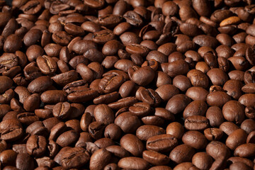 Beautiful background with coffee beans in dark colors