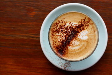 A cup of mocha coffee latte on wooden table