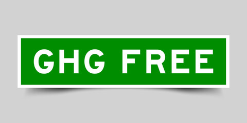 Sticker label with word GHG (Abbreviation of greenhouse gas) free in green color on gray background