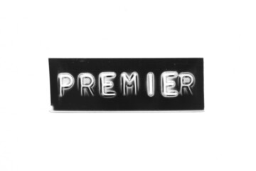 Black color banner that have embossed letter with word premier on white paper background