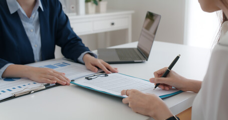 Close-up hand asia people woman fill rent loan form write legal debt letter at lawyer home office....