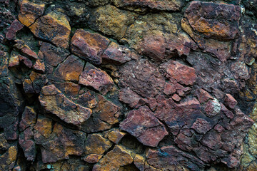 Cracked and  textured stone photo with yellow and magenta colored. Seamless and rough rock texture and pattern design. 