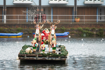 Fototapeta na wymiar Father Christmas on his sleigh on Chichester Canal West Sussex England