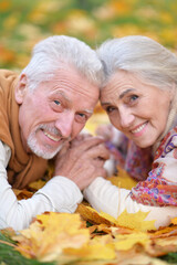 Happy senior woman and man in park