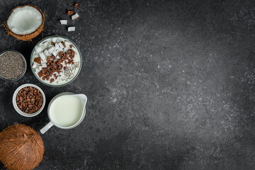 Obraz na płótnie Canvas Healthy breakfast of granola bowl with coconut milk and chia seeds. Top view, copy space.