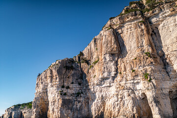 Fototapeta na wymiar High cliffs with forest and rocks on shore of Corfu island