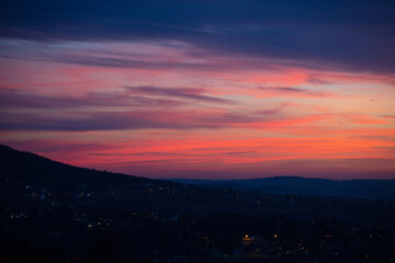 Landscape with colorful sky and streetlights.