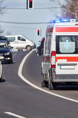 Fototapeta na wymiar Paramedic 911 ambulance car running fast through the big city.