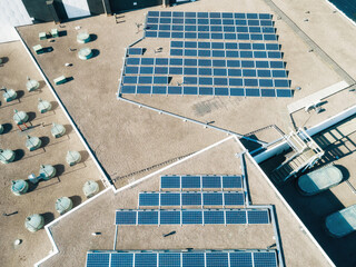 Aerial top down view of solar panels PV modules mounted on flat roof photovoltaic solar panels....
