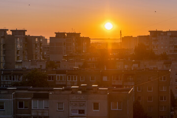 Sunrise above the rooftops of soviet buildings in Lithuania