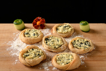 open sfiha filled with ricotta cheese and spinach on a wood