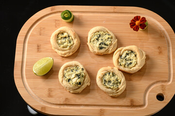 open sfiha filled with ricotta cheese and spinach on a wood