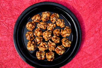 Small Peanut jaggery laddu or Peanut ladoo with pink background