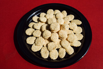 Indian Sweet food Rewri also known as rewadi or revadi is popular Indian makar sankranti festival food, Made of Jaggery or gud with sesame seeds coating.