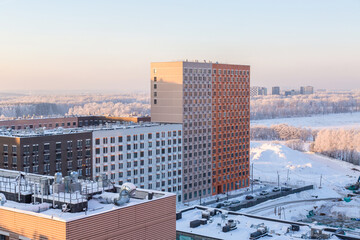 urban modern landscape: multi-colored new buildings residential buildings, windows, air conditioning, facades and constructionin winter