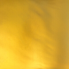 gold foil background with golden textured wall reflection