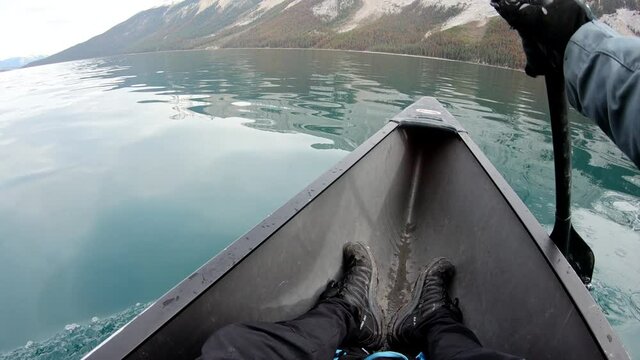Traveler canoeing on Maligne Lake with Canadian Rockies in Jasper national park