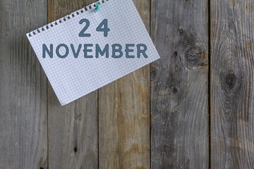Day of month.A white sheet of checkered paper from a notebook with a date is pinned with a...