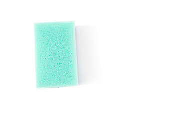 Foam sponge for washing dishes of light green color on a white background, isolate. Top view, flat lay, copy space, isolated on white background. High quality photo