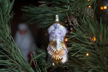 Vintage old glass Christmas tree toy 1970s Soviet period dolls - beautiful tsarina on pine branches close-up.
