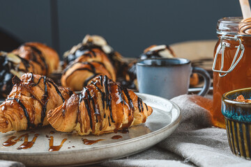 croissants with chocolate and honey on the table with.