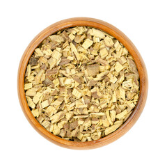 Liquorice root  chips, in a wooden bowl. Dried, cut root of licorice, Glycyrrhiza glabra. Used as tea, or as sweet extract for flavouring candies, sweets and tobacco. Also used in traditional medicine