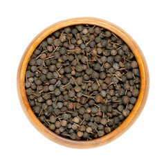 Cubeb berries, known as tailed pepper or Java pepper, in a wooden bowl. Dark brown berries, with their stalks still attached. Dried fruits of Piper cubeba, used as seasoning with mild pepper flavor.