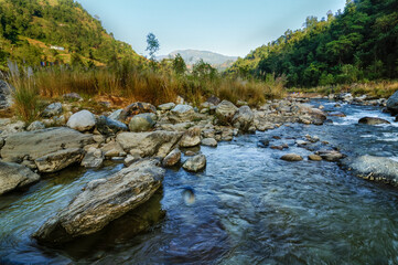 Water of Reshi River flowing on rocks at dawn, Sikkim, India. Himalayan river.