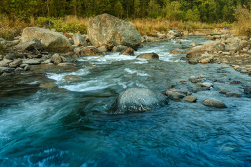 Beautiful Reshi River water flowing through stones and rocks at dawn, Sikkim, India. Reshi is one...