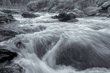 Beautiful Reshi River water flowing through stones and rocks at dawn, Sikkim, India. Reshi is one...