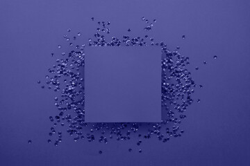 Purple card on a purple background with purple sequins. Preparation for various celebrations. Festive background.