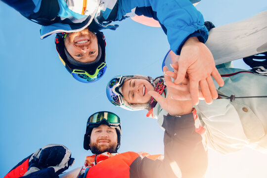 Team of friends man and woman skiing and snowboard make selfie photo in winter with sun light on ski resort