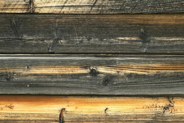 Close-up view of old wooden wall of rusty house. Beautiful wooden texture.