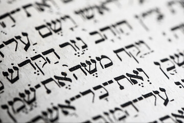 Closeup of hebrew word in Torah page that translates in english as Moses, name prophet in Judaism,...